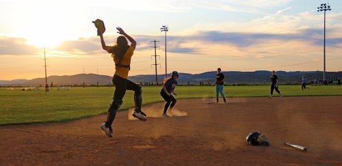 Catcher saves errant throw during club softball practice