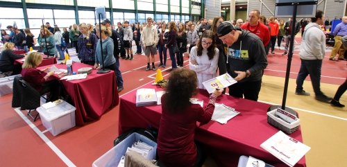 Prospective students and parents check in during a fall open house event